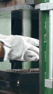 Worker add rubber material into press machine