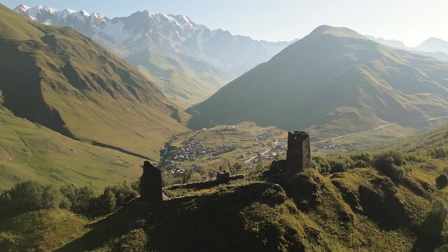 Aerial circular panoramic view Georgia Queen Tamar fortress medieval castle tower and complex and Ushguli village in Caucasus mountains. Famous hiking destination in Ushguli area. Svaneti. Georgia