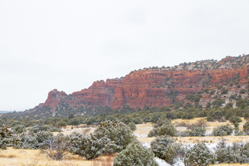 Fototapeta premium Fog and snow on sandstone formations in Red Rock State Park in Sedona, Arizona