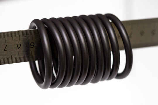 Rubber O-rings sealing industrial components, used for leak prevention in plumbing and machinery, arranged on a clean white background&mdash;ideal reference for designers working on engineering, maintenance
