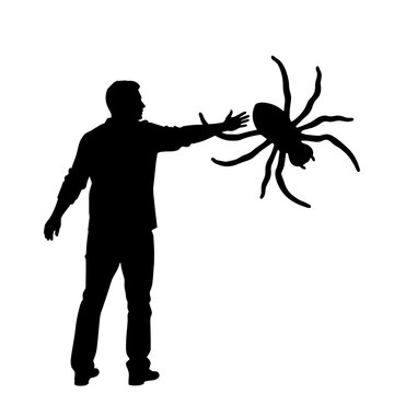 Man reaching out to large spider in playful April 1 concept  