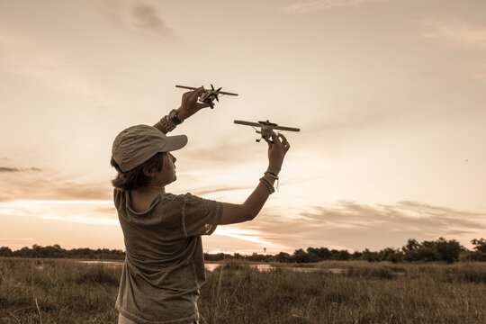 young boy "flying" wooden safari plane,Okavango Delta, Botswana, Africa