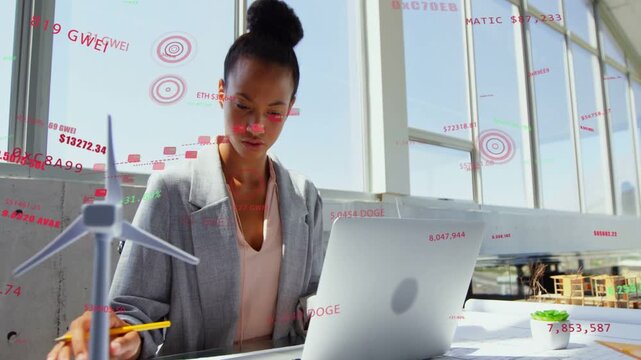Woman studying plans, marking notes, tapping laptop activating AR charts and crypto data analyzing