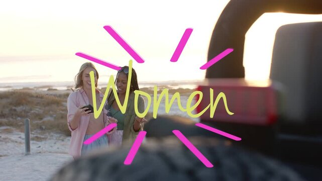 Women raising phone, posing for selfie on beach sunset, social overlay animating with pink rays