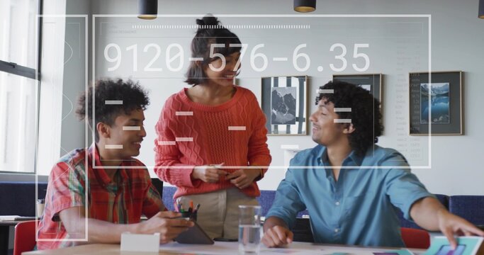 Leading woman in rust-red sweater holding notes in office, two men using tablet stylus and overlay