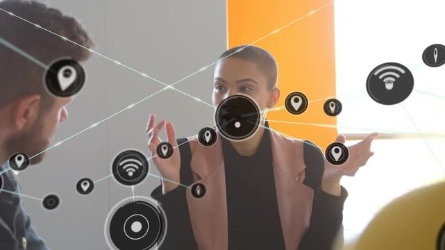 Seated woman speaking and gesturing, causing wifi, location, target nodes connecting in business