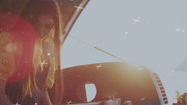 Woman vendor leaning into food truck, reaching and making wrap as crosses and flare showing food