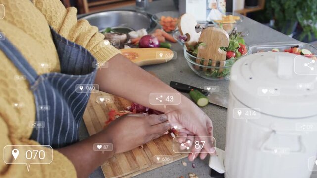 Woman reaching scrap flap chopping red onion on board while social icons tracking hand making salad