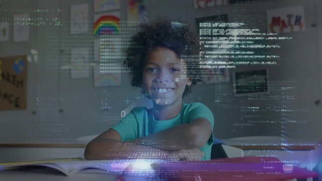 Male student sitting at school desk while onscreen code appearing and visualizing math via workbook