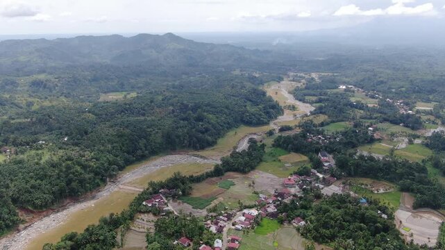 Agam, Indonesia - April 3rd 2026: Aerial Drone Forward Tracking of Vast Hills and Plantations in Salareh Aia Timur: Wide Landscape View of Rural Area Near Flash Flood Disaster Zone