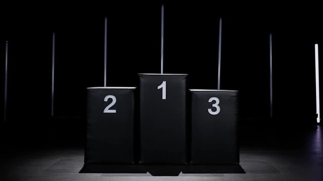 Slow pan tracking shot of winners podium with numbered tiers 1 2 3 and illuminated vertical lights in dark studio stage setting