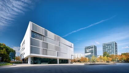 Obraz premium modernist five story white public building with large windows and town center in background