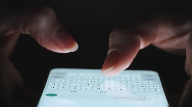 Female hands typing text on smartphone close-up.