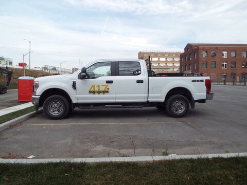 Ottawa, Ontario, Canada &ndash; August 02, 2025: A white "Kiewit Dufferin Partnership construction pickup" truck is parked in a lot near an office building and construction site on Orangeville St.