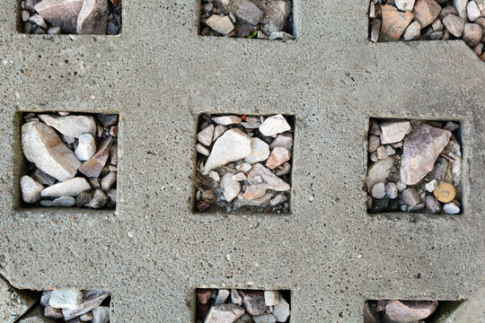Close-up of a stone sidewalk. Background texture of the sidewalk with a geometric square pattern.