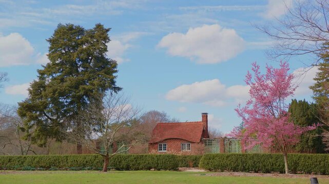 view of Coe Hall, the historic Tudor Revival mansion at Planting Fields Arboretum State Historic Park in Oyster Bay, Long Island, New York. The image captures the architectural beauty of the mansion a