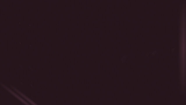 Deep crimson abstract texture with subtle vertical light streaks and scattered dust particles