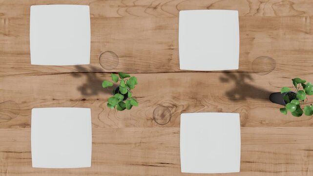 Top-down desk setup with four white sticky notes on a wooden table for planning and teamwork.