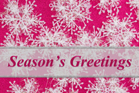 Seasons greetings with snowflakes on glitter pink