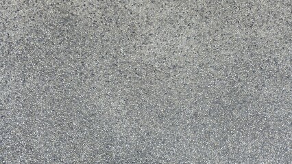 Fototapeta premium Gray gravel concrete floor, road surface, walkway surface, small gravel road surface, texture, and background. Gray exposed aggregate concrete texture with fine pebbles.
