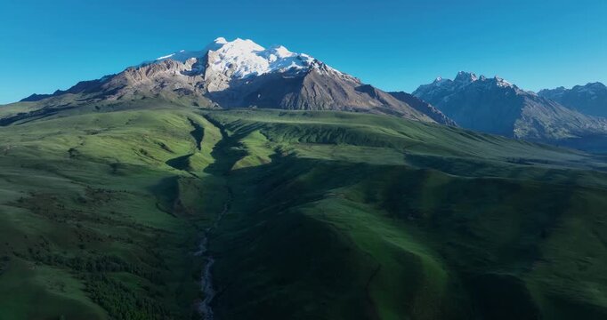 Beautiful green grassland and snow capped mountain in Litang county, China