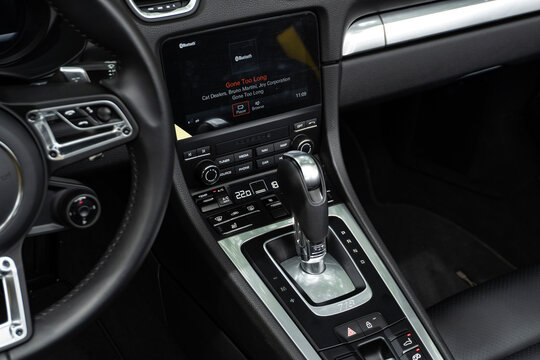 Porsche 718 Boxster gear shifter and media screen, Luxury convertible sports car center console interior view