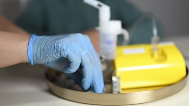 Close-up of Hands with Syringe Injecting Medication into a Saline Solution Bag