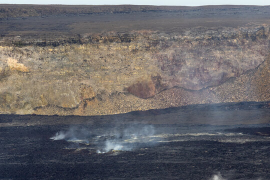 Rugged volcanic crater wall and smoking ground inside the Kilauea caldera at Hawaii Volcanoes National Park Big Island Hawaii