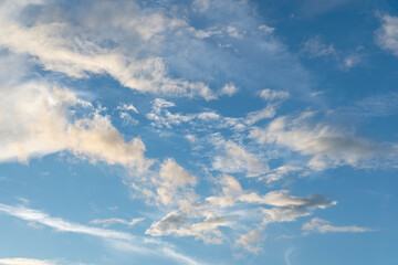 Fototapeta premium blue sky with soft white clouds drifting gently, calm atmosphere, bright natural light, serene summer sky scene