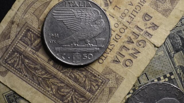 Old Italian coins and banknotes rotating &ndash; vintage money, European currency and economy concept