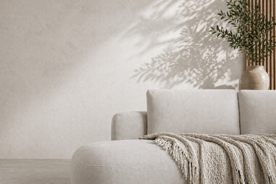 Cozy beige couch in modern Scandinavian style room with soft fabric cushions, woven blanket and natural sunlight across empty wall.
Great for interior branding.