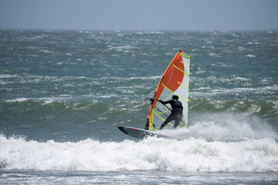 Windsurfer on the ocean on a very windy day