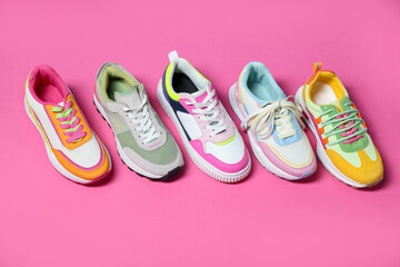 Stylish bright sneakers on pink background. Sports shoes