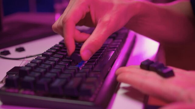 Keyboard modding scene. Closeup of key replacement in vibrant studio setting. Dynamic view of mechanical key modding process illuminated by bright pink studio lighting