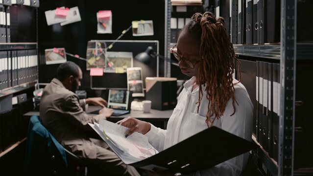 Private inspectors working with criminal records in police archive office, examining forensic evidence to find clues. Young team of detectives doing background checks, catching suspect.