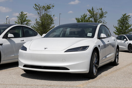 Tesla Model 3 Electric Sport Sedan at a dealership. Tesla offers the Model 3 with up to 321 miles driving range. MY:2026