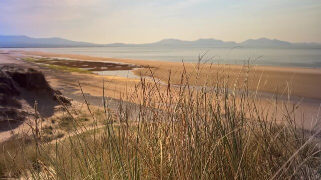 Panoramic View of Newborough Beach and Snowdonia Mountains from Isle of Anglesey, Wales, UK