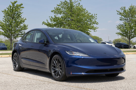 Tesla Model 3 Electric Sport Sedan at a dealership. Tesla offers the Model 3 with up to 321 miles driving range. MY:2026