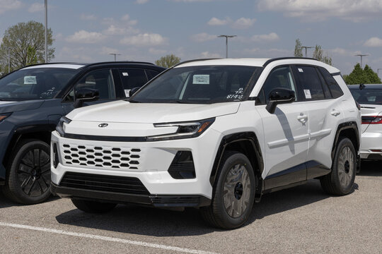 Toyota RAV4 SE Plug-In Hybrid AWD SUV at a dealership. Toyota offers the RAV4 with a 2.4L 4-Cylinder Hybrid engine. MY:2026