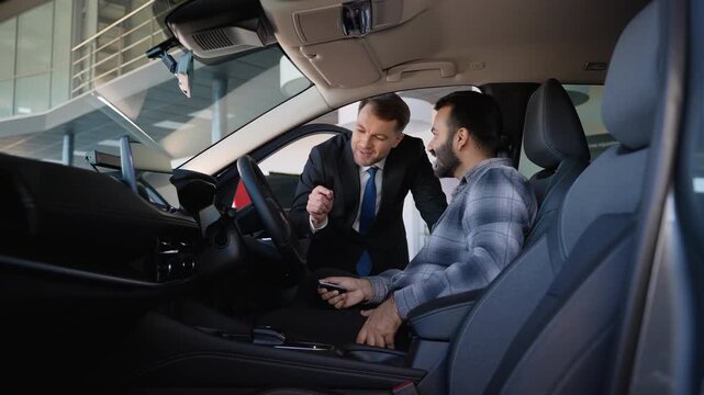 Car salesman demonstrating new vehicle to customer
