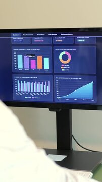 Business analyst reviews dashboard showing cost savings, ROI, and workforce readiness for AI integration and job replacement - SaaS layoff concept