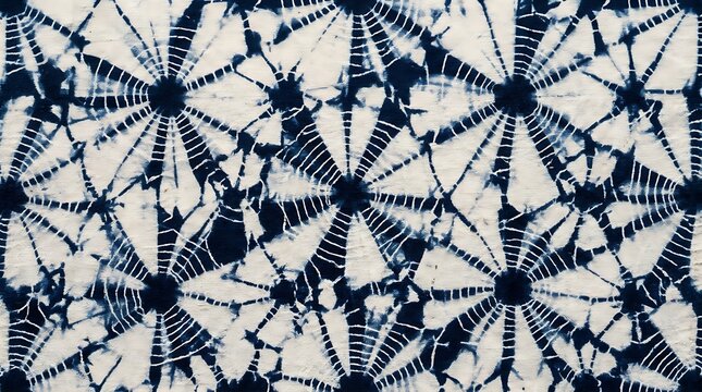 Traditional Japanese Indigo Shibori Tie Dye Pattern with Spider Web Starburst Motif on White Cotton Fabric Background