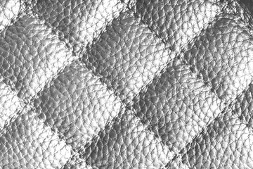 Fototapeta premium Close up, macro of white quilted leather texture with stitched diamond pattern, luxury material surface shining metal effect for fashion, upholstery or design wallpaper, rough, relief background