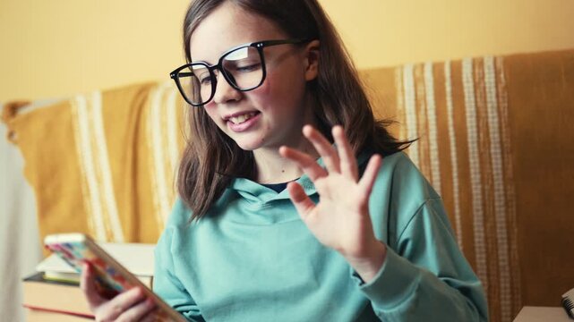 Little Girl in Glasses Talking on Video Call via Smartphone, Child Using Mobile Phone for Online Chat, 4K 10-bit
