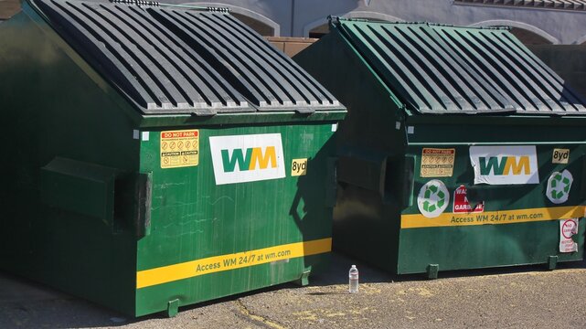 Waste Management (WM) dumpsters for trash and recycling outside city business, Tucson, Arizona, United States - April 20, 2026