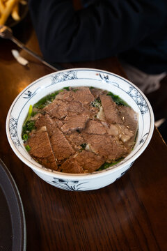 generous bowl of traditional Vietnamese Beef Pho served in a blue-and-white patterned ceramic bowl