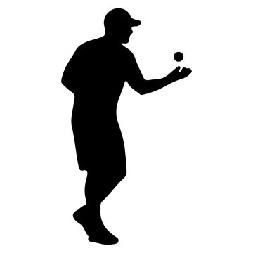 Silhouette of a man playing bocce ball.
