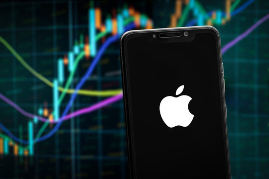 Cali, Colombia - June 12 2022: Apple logo on the smartphone screen and the chart of stock market at the blurred background.