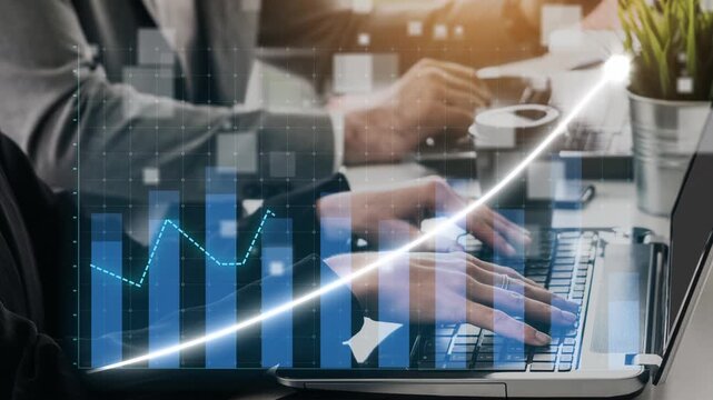 This image depicts business professionals analyzing growth and financial data on a laptop, showcasing modern technology and effective workplace collaboration. Copula
