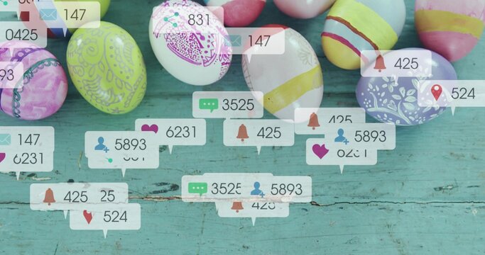 Showing cluster of decorated Easter eggs sitting on worn turquoise table, with notification bubbles